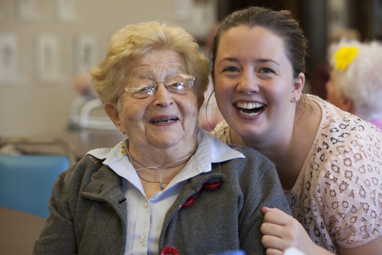 Resident and staff laughing together