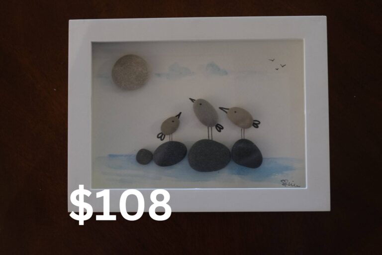 Art made with organic materials to depict birds standing on rocks in the water.