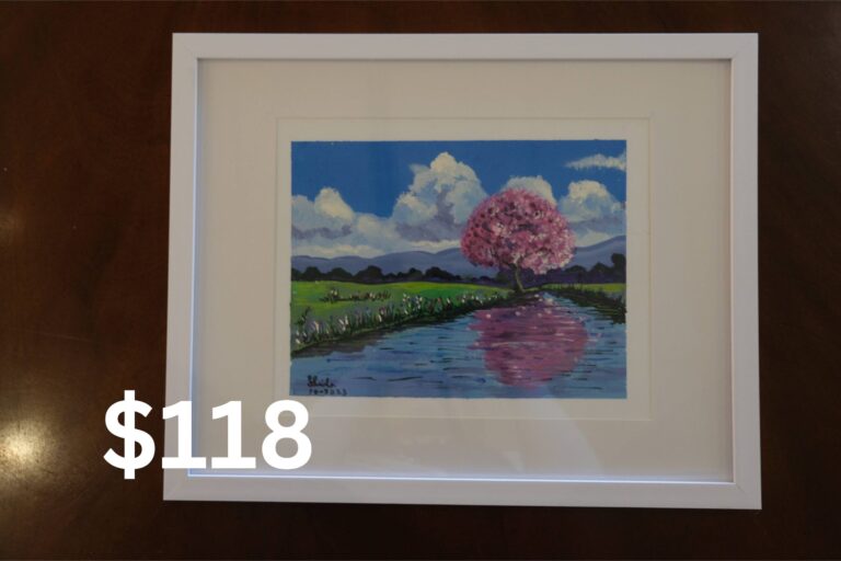 Lake scene with a pink tree painting.