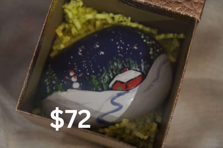 Snowscape scene painted on a rock in a box.