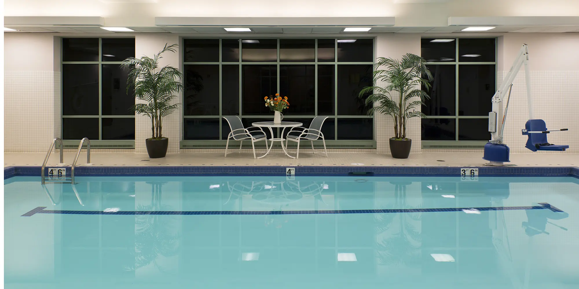 indoor swimming pool with chair lift in shallow end